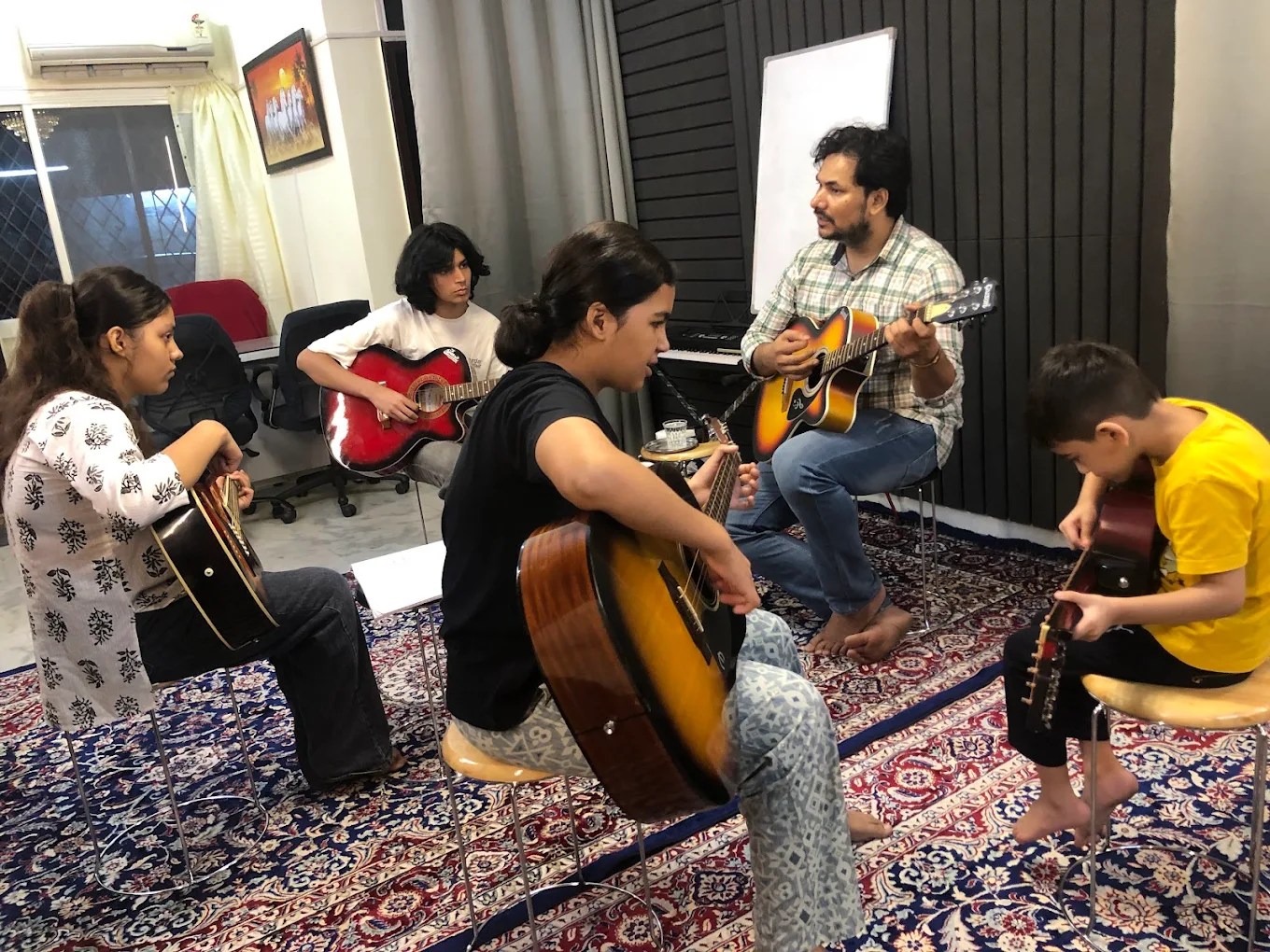 A small-batch guitar class in session